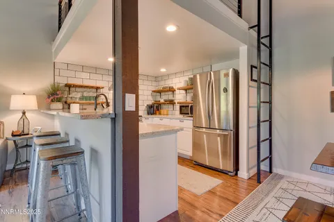 a kitchen with stainless steel appliances a refrigerator and a stove