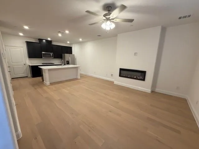 a view of kitchen with kitchen island microwave and stove