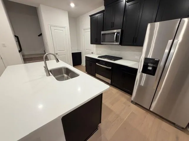 a kitchen with a refrigerator and a sink