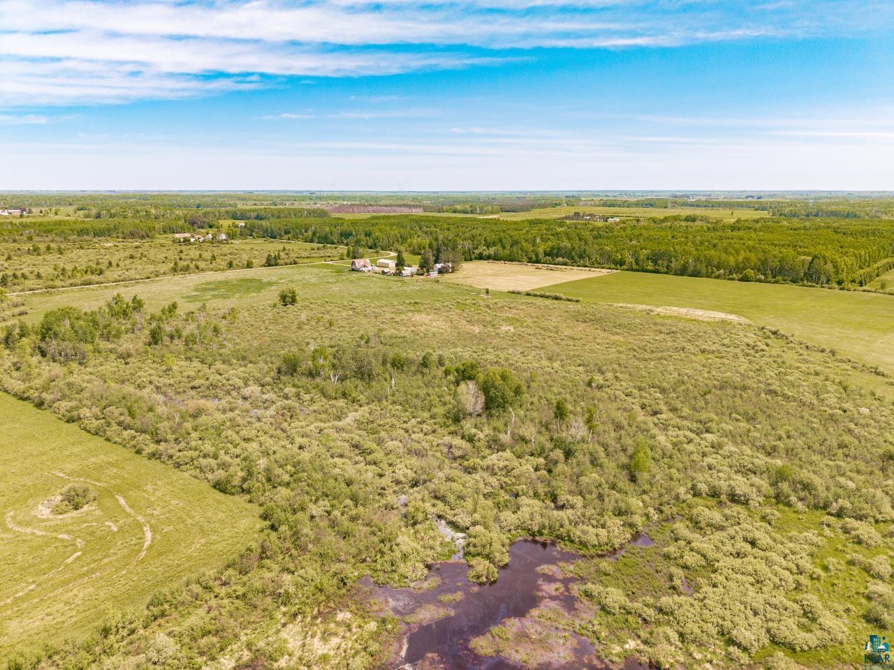 6606 Metso Road Kettle River, MN 55757 - Photo 55 of 84 Expansive rural landscape featuring a mix of open fields, wooded areas, and marshland