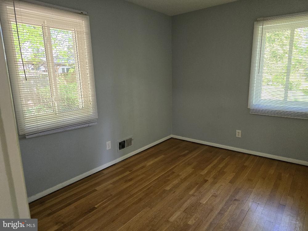 7612 Clive Place Springfield, VA 22151 - Photo 11 of 23 an empty room with wooden floor and windows
