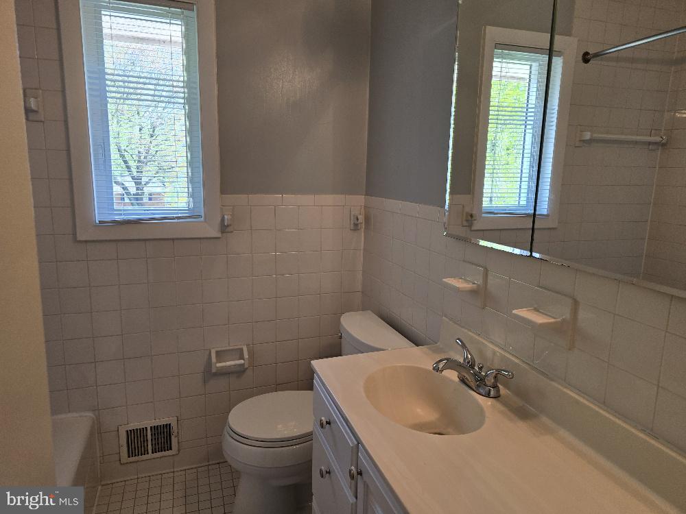 7612 Clive Place Springfield, VA 22151 - Photo 15 of 23 a bathroom with a sink toilet and mirror