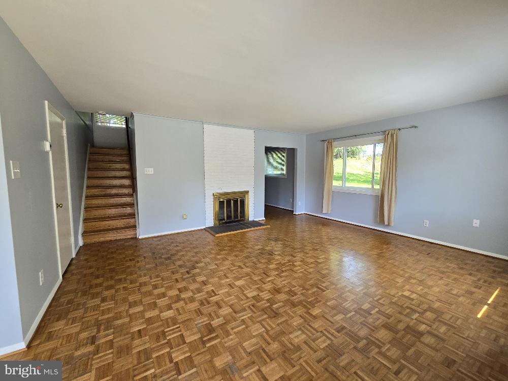 7612 Clive Place Springfield, VA 22151 - Photo 2 of 23 an empty room with windows and fireplace
