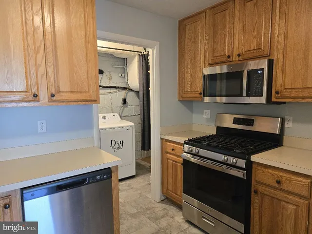 a kitchen with stainless steel appliances granite countertop a stove and a microwave