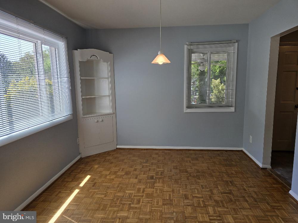 7612 Clive Place Springfield, VA 22151 - Photo 8 of 23 a view of an empty room with window and wooden floor