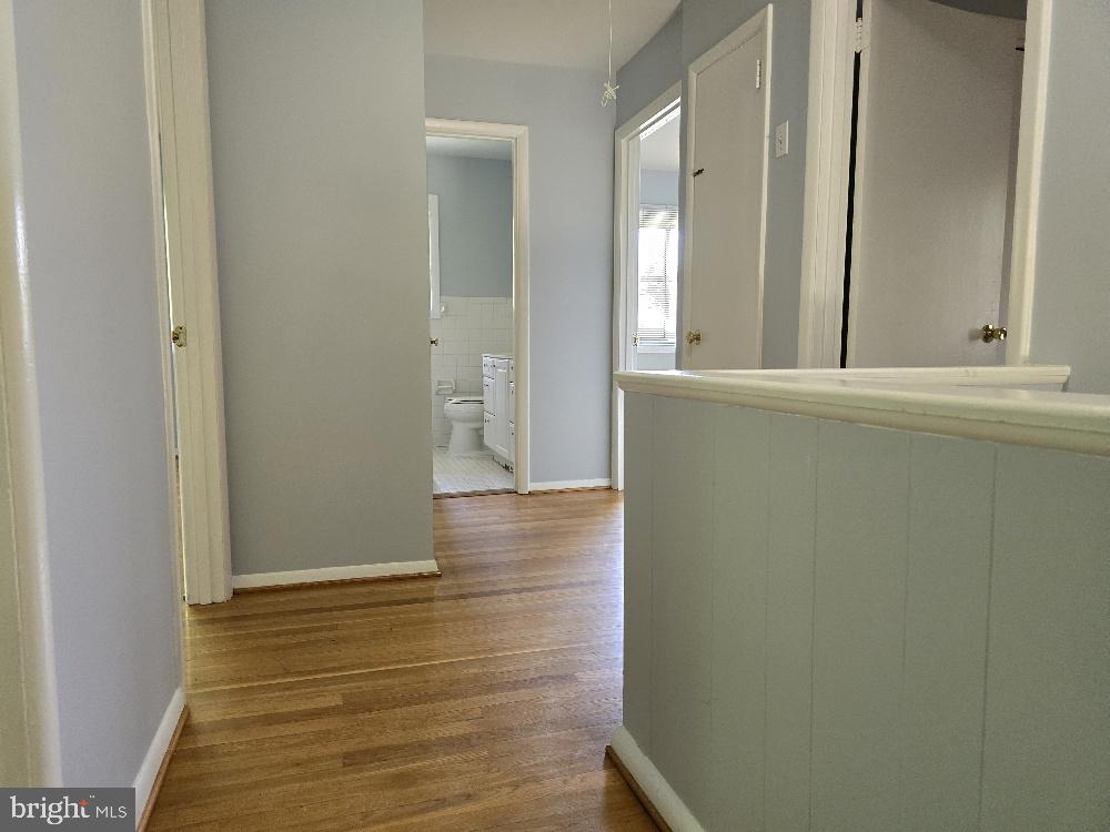 7612 Clive Place Springfield, VA 22151 - Photo 10 of 23 a view of a hallway with wooden floor