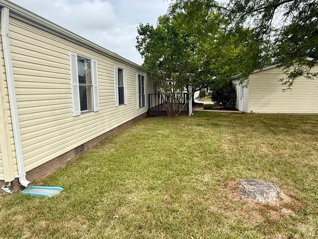 a backyard of a house with lots of green space