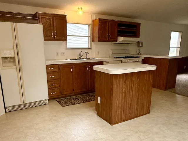 a kitchen with a sink and a refrigerator