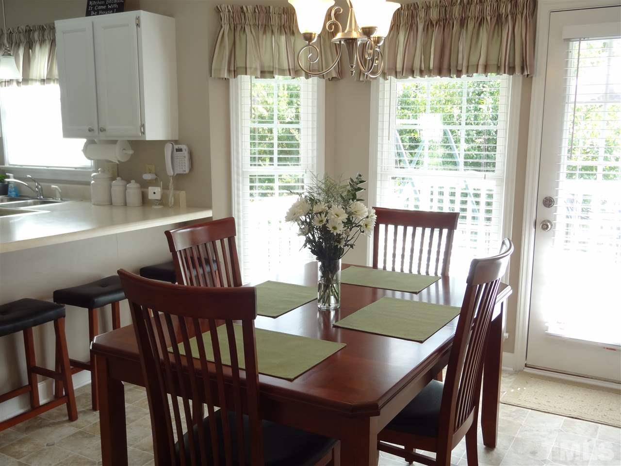 4416 Bartholomew Circle Raleigh, NC 27604 - Photo 14 of 24 a view of a dining room with furniture window and outside view