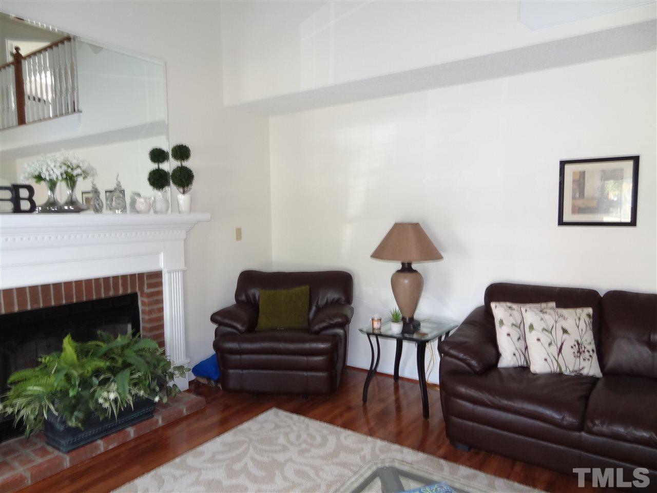 4416 Bartholomew Circle Raleigh, NC 27604 - Photo 4 of 24 a living room with furniture and a fireplace