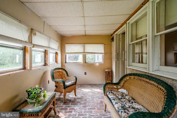 a living room with furniture and large windows