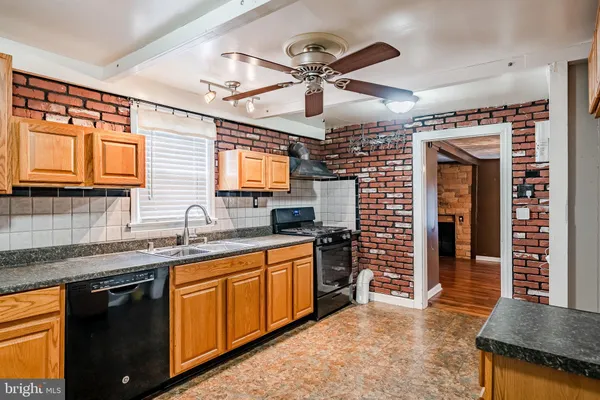 a kitchen with stainless steel appliances granite countertop a sink and cabinets