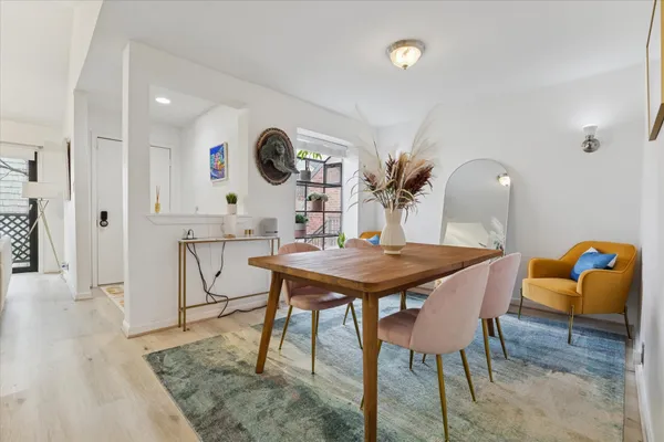 a view of a dining room with furniture and wooden floor