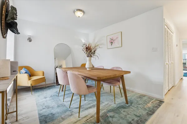 a dining room with furniture and wooden floor
