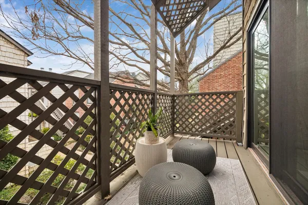a view of a chairs and table in the balcony