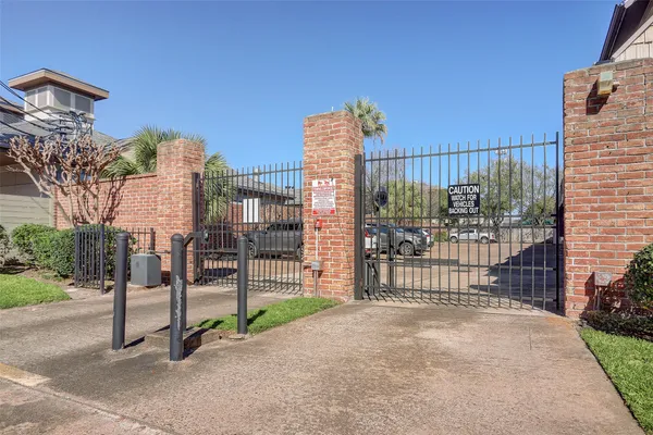 a view of a park with iron fence