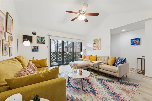 a living room with furniture ceiling fan and a rug