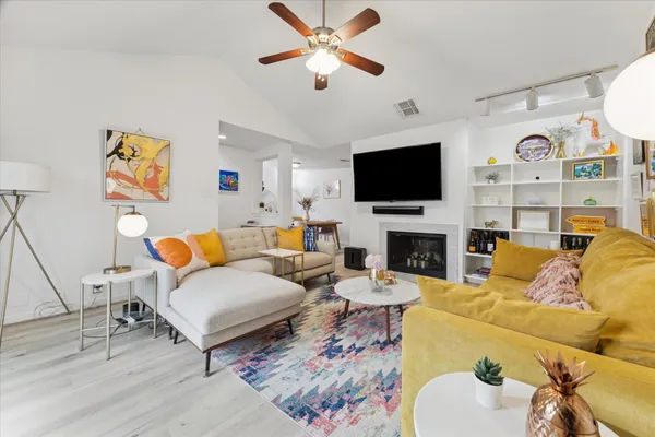 a living room with furniture a fireplace and a flat screen tv