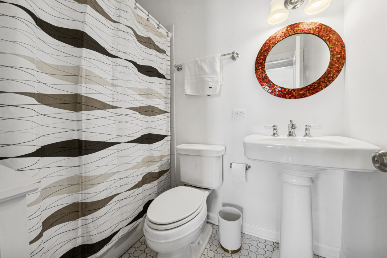 4834 North Kenmore Avenue, Unit 3N Chicago, IL 60640 - Photo 17 of 28 a bathroom with a sink and a mirror