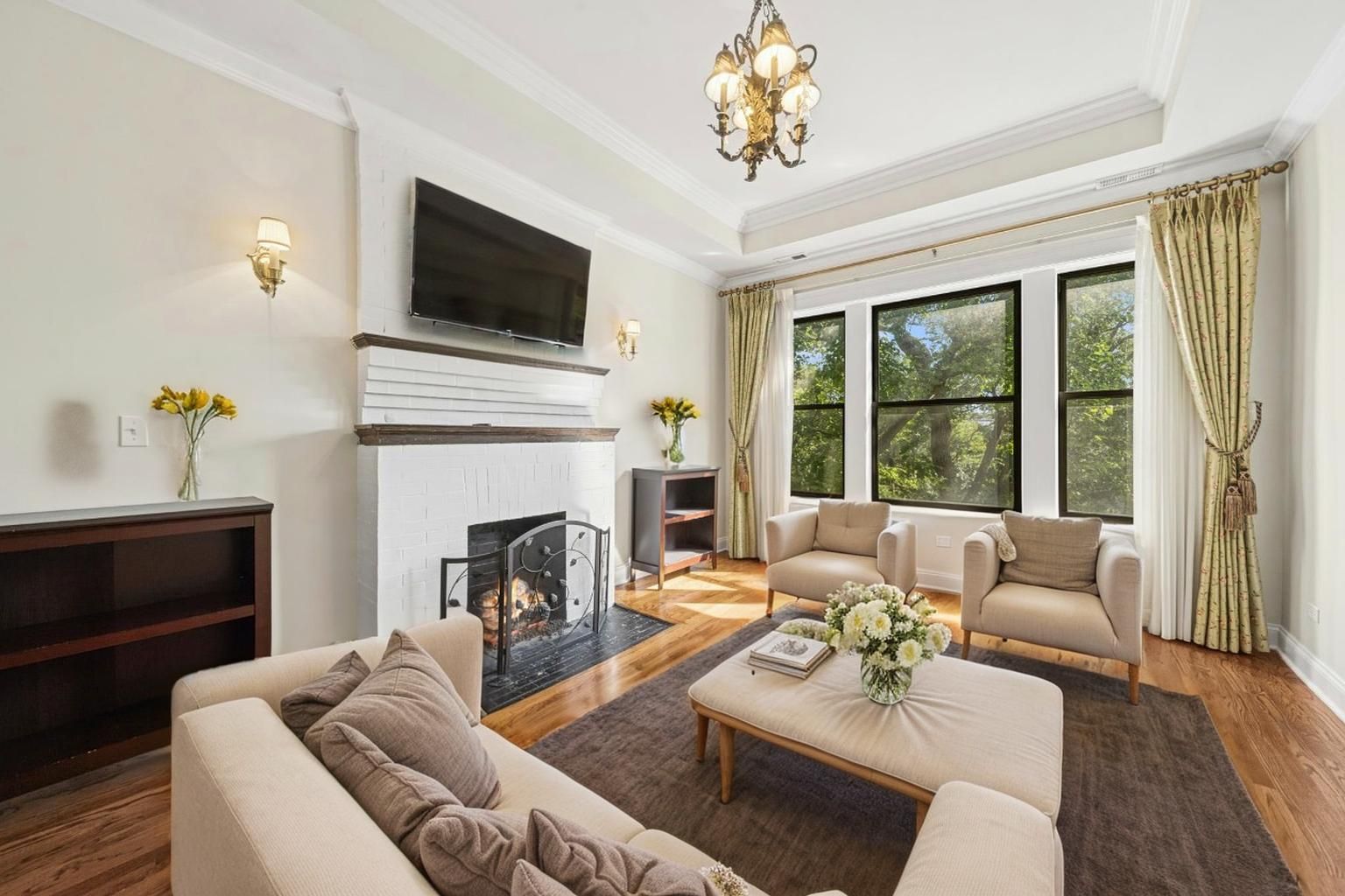 4834 North Kenmore Avenue, Unit 3N Chicago, IL 60640 - Photo 2 of 28 a living room with furniture a fireplace and a flat screen tv
