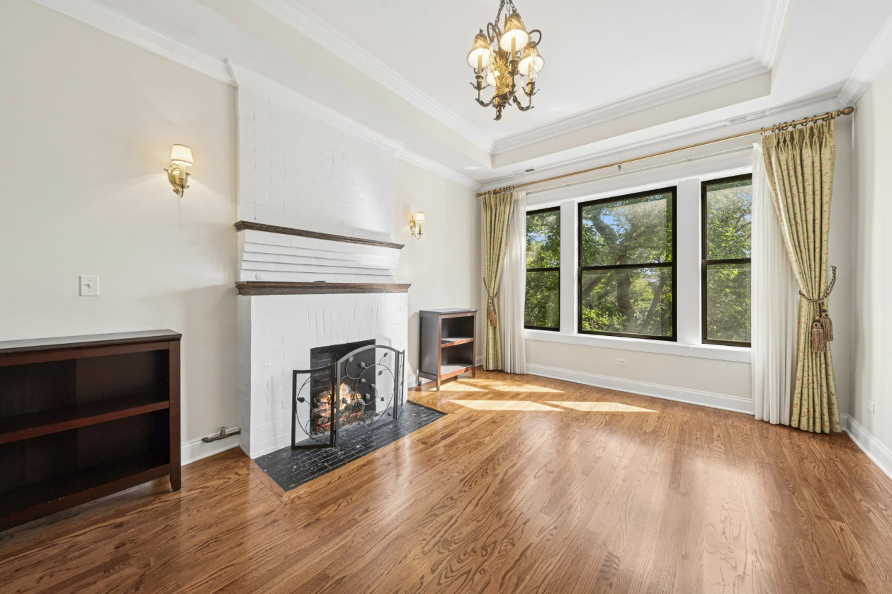 4834 North Kenmore Avenue, Unit 3N Chicago, IL 60640 - Photo 3 of 28 a view of a livingroom with a fireplace wooden floor and windows