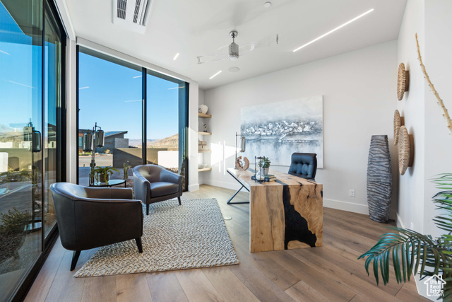 3558 South Cypress Road Hurricane, UT 84737 - Photo 14 of 57 Living room with floor to ceiling windows, light hardwood / wood-style floors, and ceiling fan