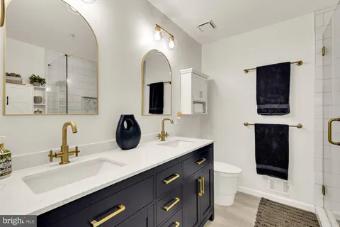 a bathroom with a double vanity sink and a mirror