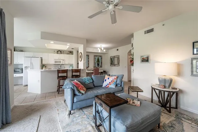 a living room with furniture and kitchen view