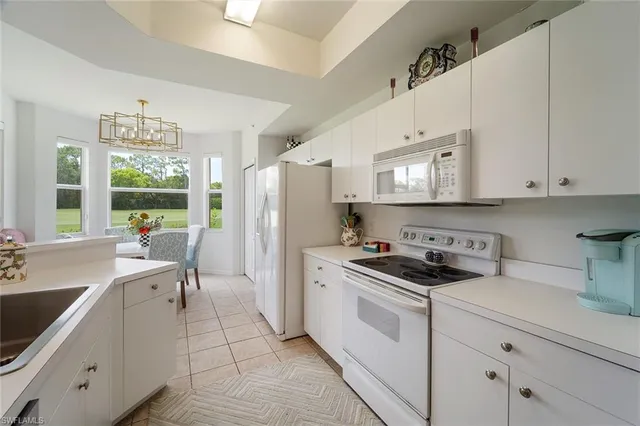 a kitchen with a white cabinets and white appliances