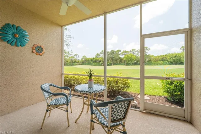 a living room with patio furniture and a garden