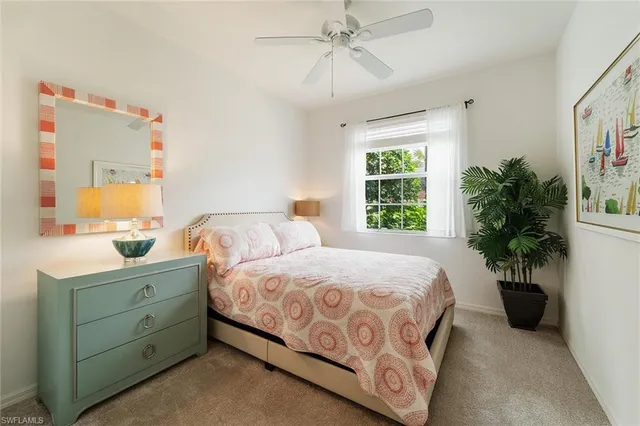 a bedroom with a bed and a potted plant