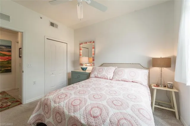 a bedroom with a bed and a lamp