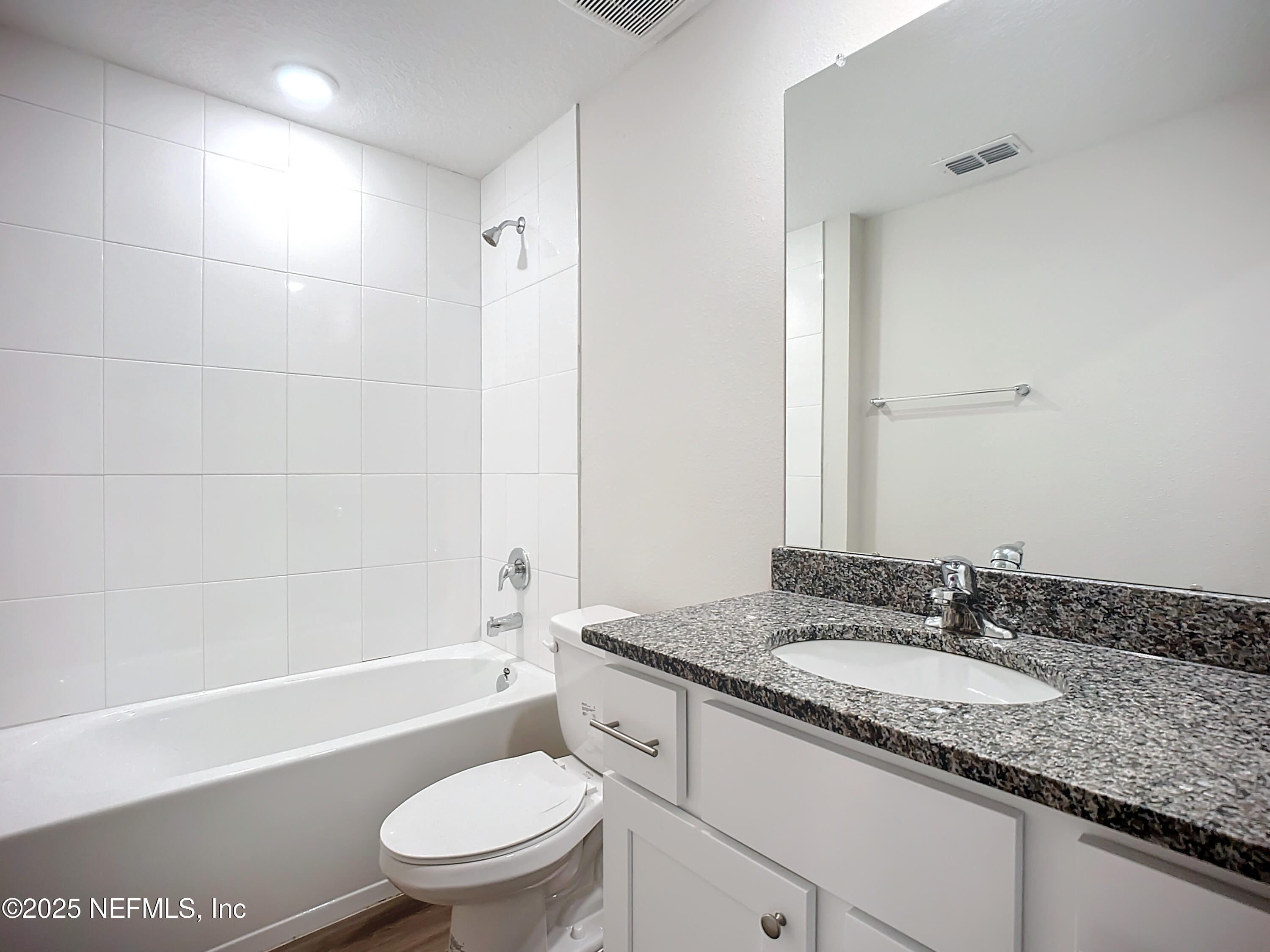 9612 Hood Road Jacksonville, FL 32257 - Photo 13 of 20 a bathroom with a granite countertop sink a toilet and shower