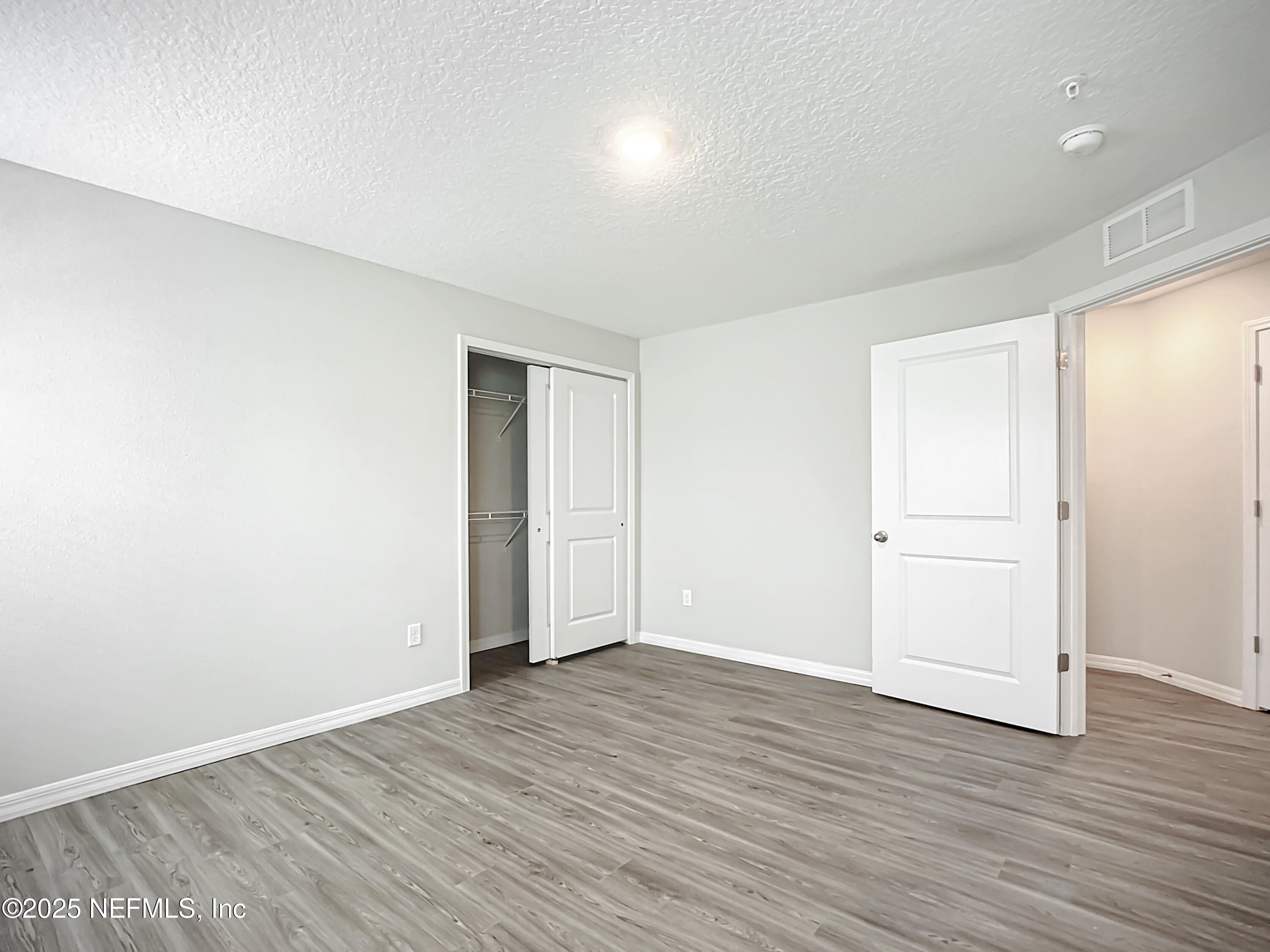 9612 Hood Road Jacksonville, FL 32257 - Photo 14 of 20 a view of an empty room with wooden floor