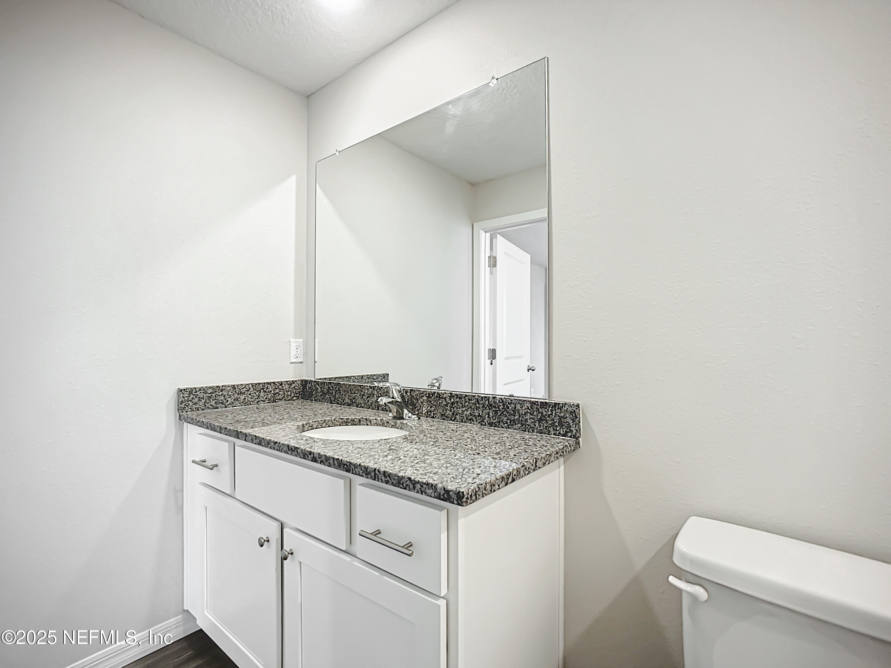 9612 Hood Road Jacksonville, FL 32257 - Photo 18 of 20 a bathroom with a granite countertop sink and a toilet