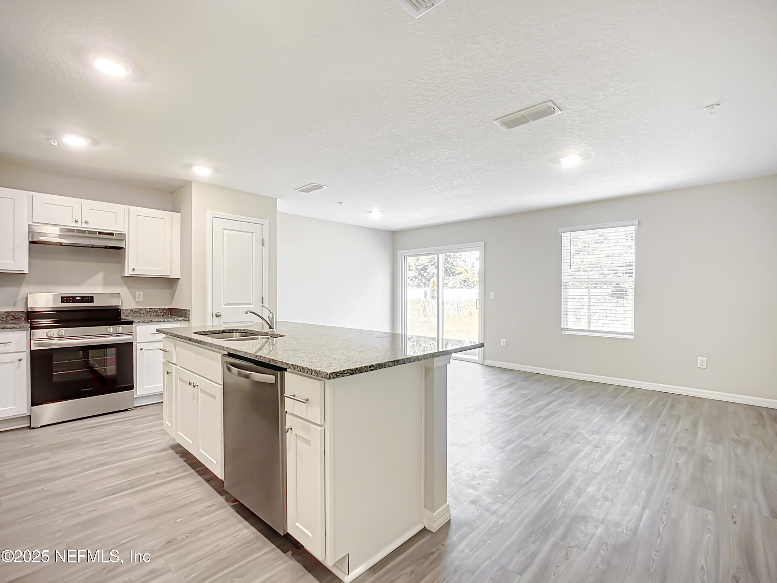 9612 Hood Road Jacksonville, FL 32257 - Photo 5 of 20 a kitchen with granite countertop a stove and a sink