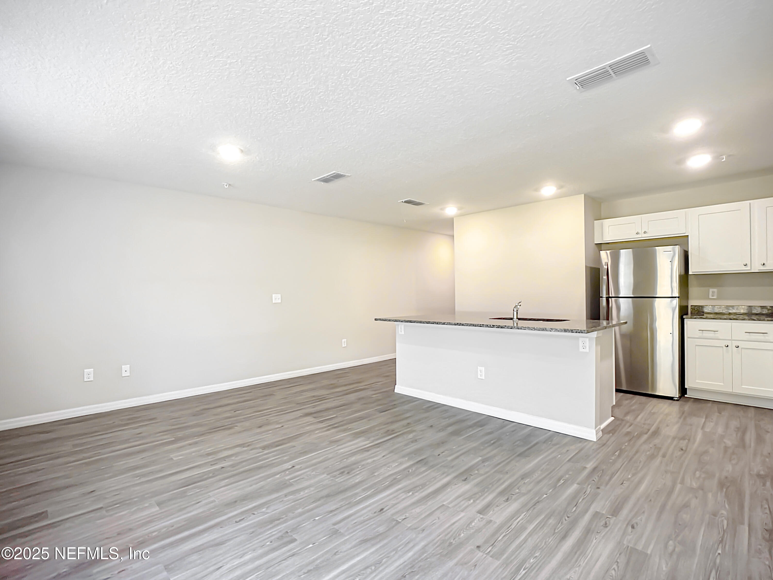 9612 Hood Road Jacksonville, FL 32257 - Photo 7 of 20 a view of kitchen with refrigerator cabinets and wooden floor