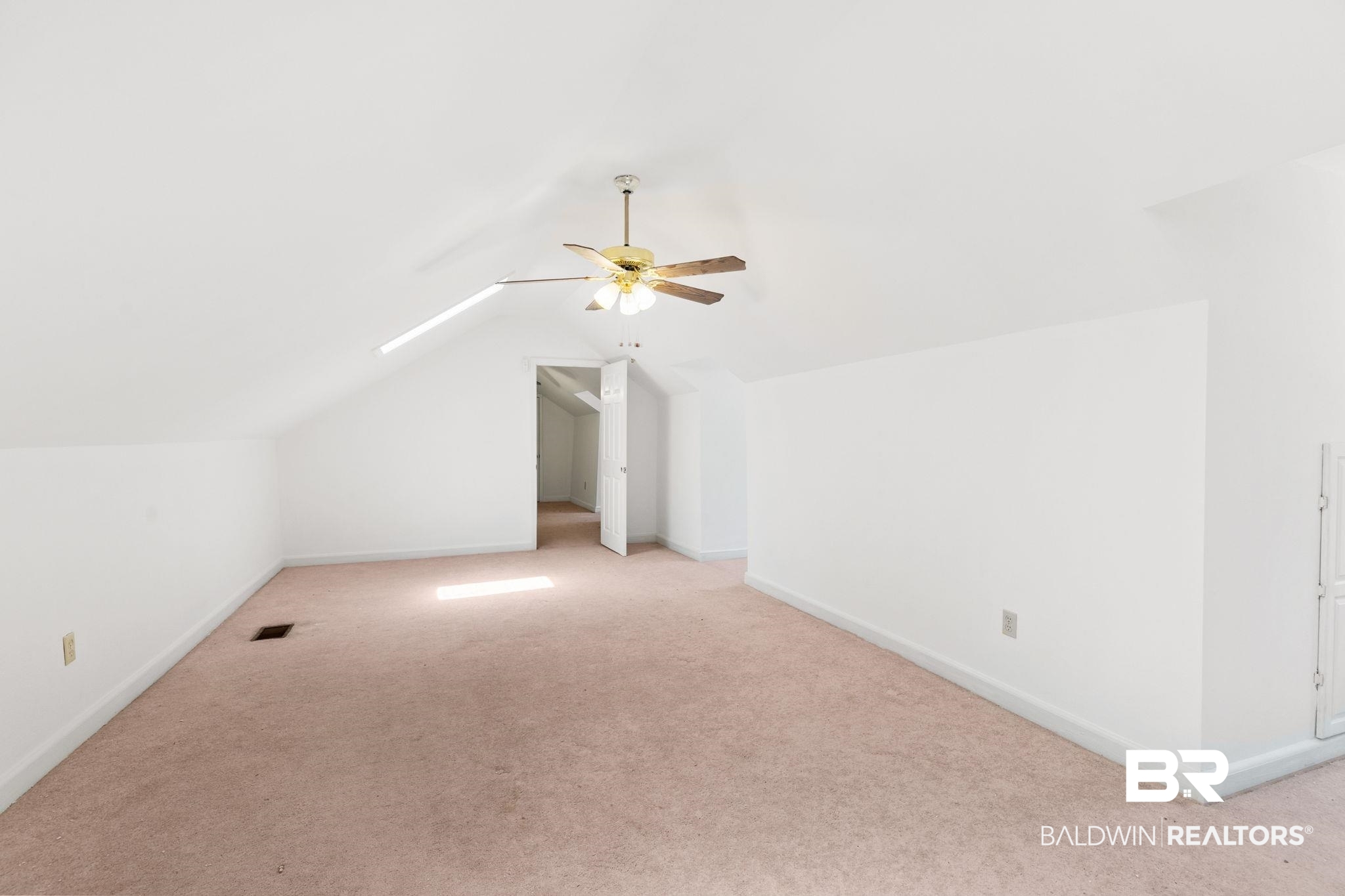 927 Cleveland Road Saraland, AL 36571 - Photo 44 of 80 Spacious room featuring vaulted ceilings, a ceiling fan with integrated lighting, soft carpet flooring, and white painted walls