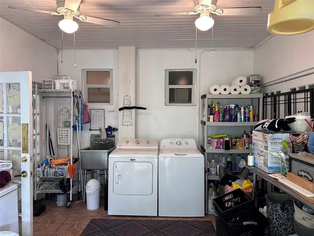 a white toilet sitting next to a bathroom sink and vanity
