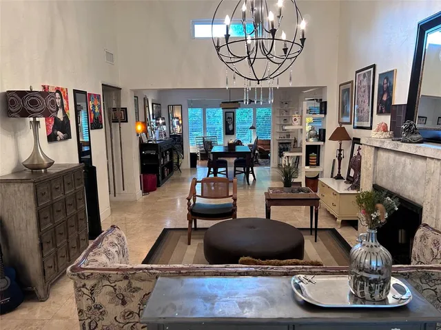 a kitchen with stainless steel appliances granite countertop a table chairs sink and cabinets