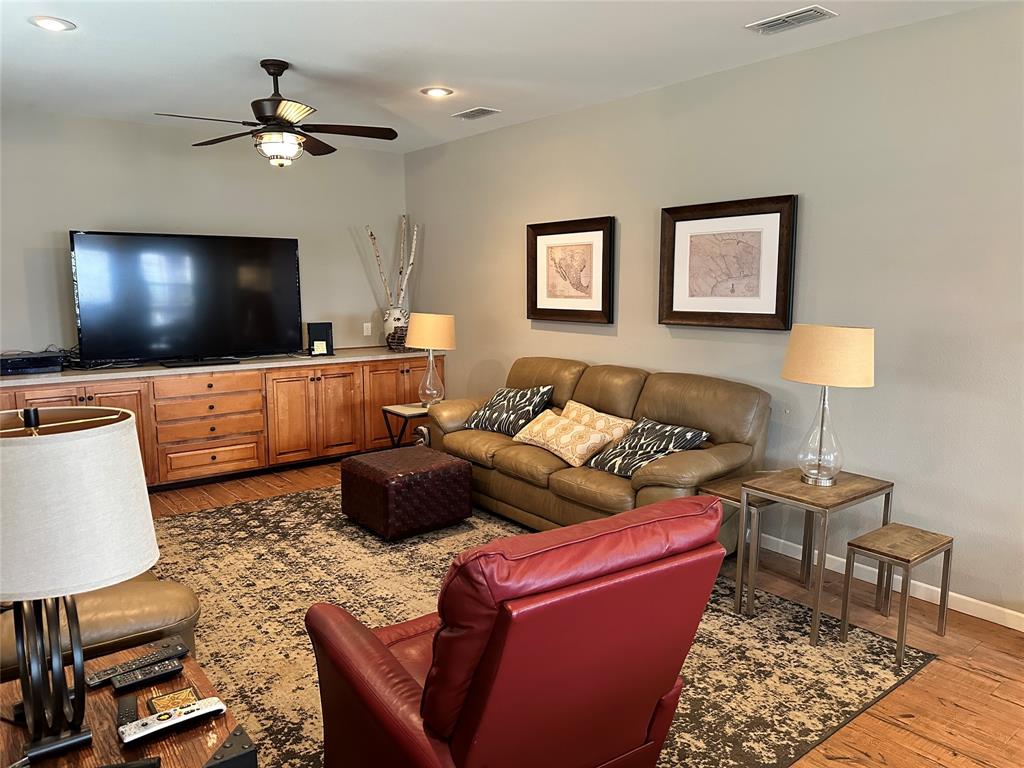 11001 West Lake Road Abilene, TX 79601 - Photo 20 of 40 Living area featuring a ceiling fan, baseboards, light wood-style floors, and visible vents