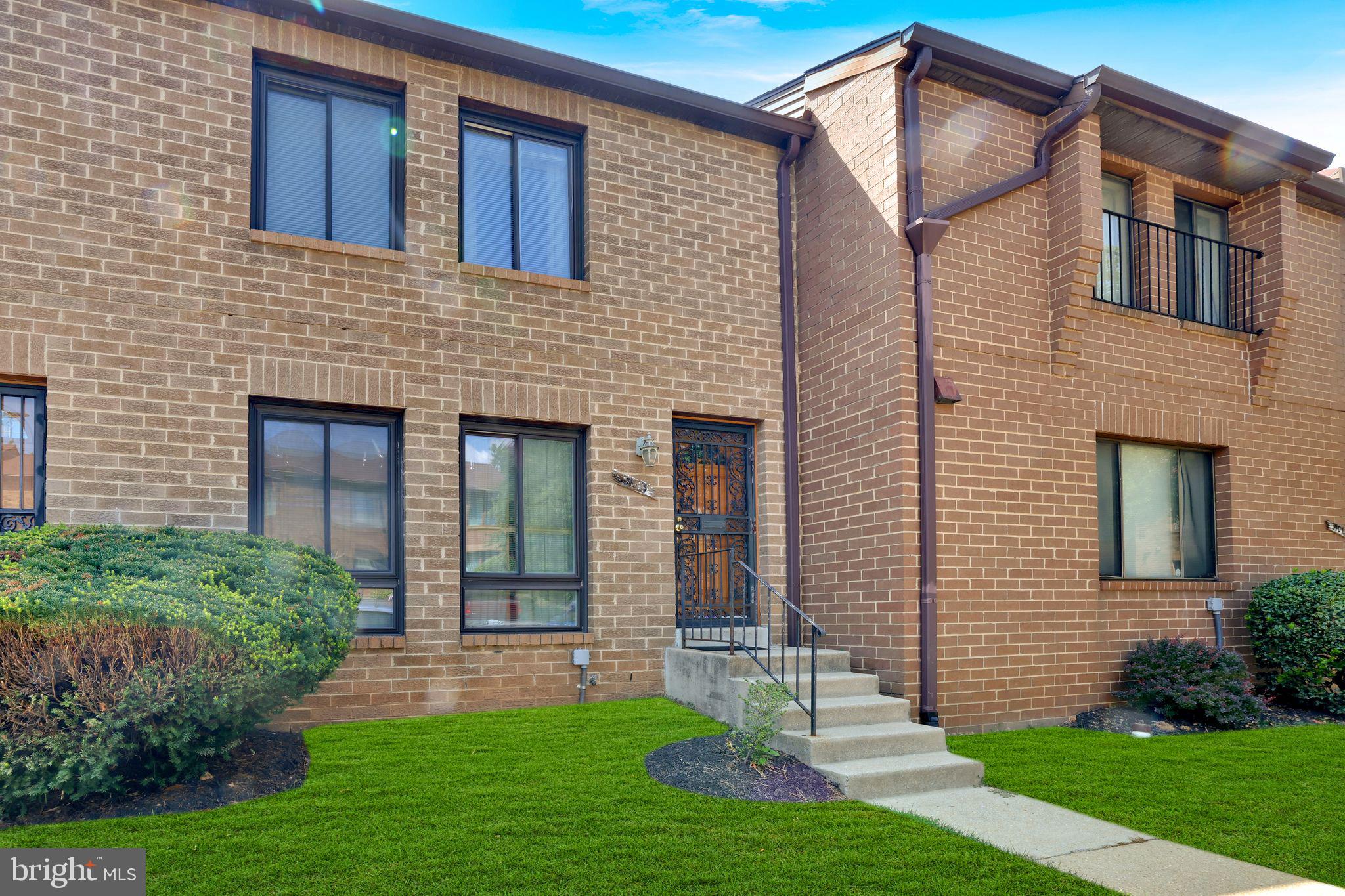 3103 Apple Road Northeast, Unit 1 Washington, DC 20018 - Photo 1 of 4 a front view of a house with a yard and green space