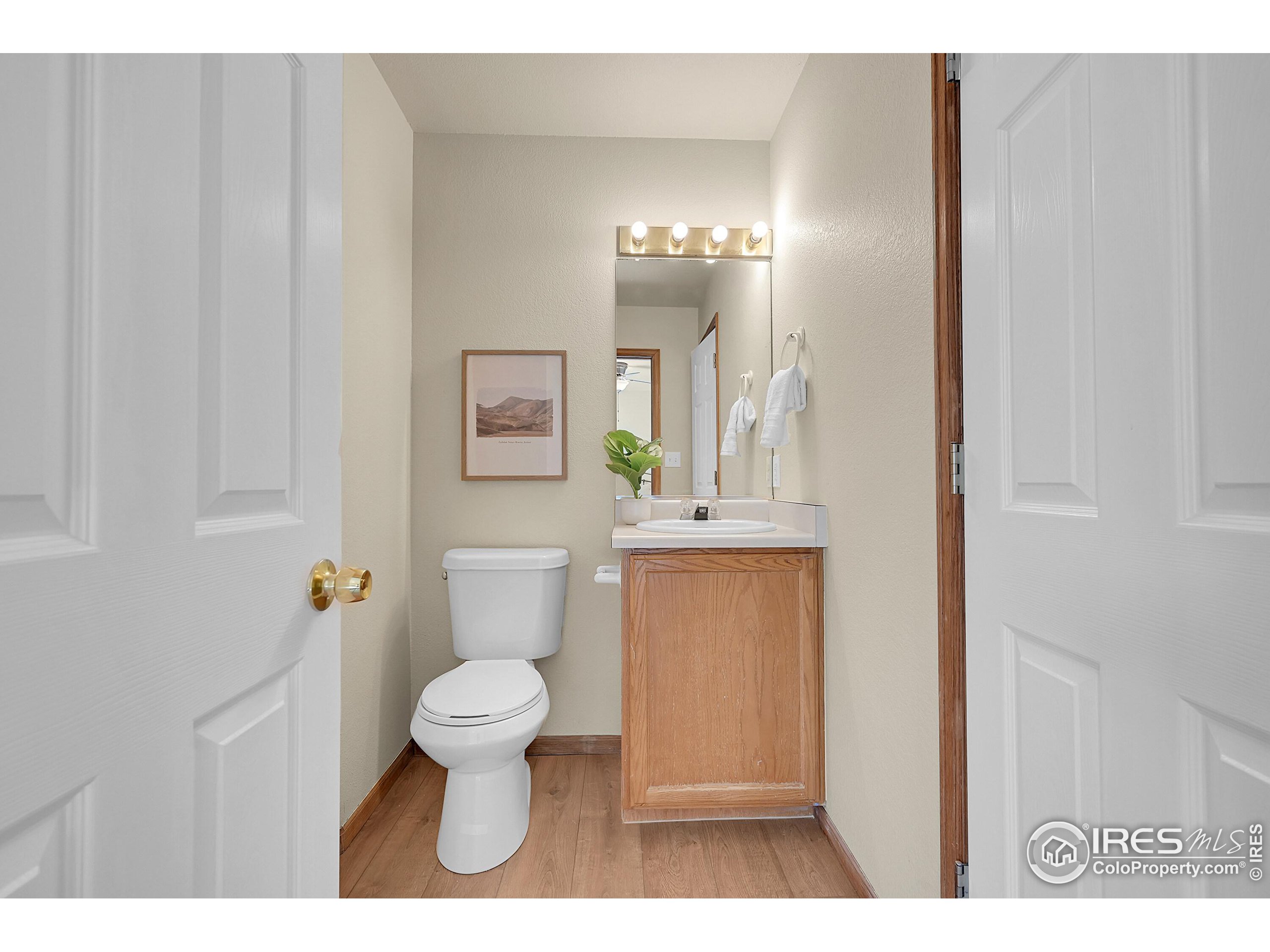 1325 Darrell Road Evans, CO 80620 - Photo 12 of 25 a bathroom with a toilet a sink and mirror