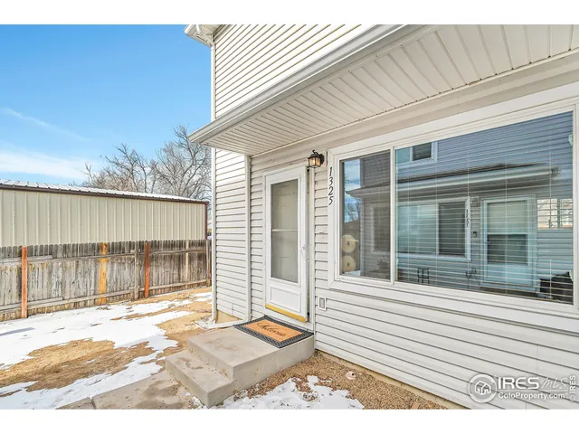 a view of a house with a small backyard
