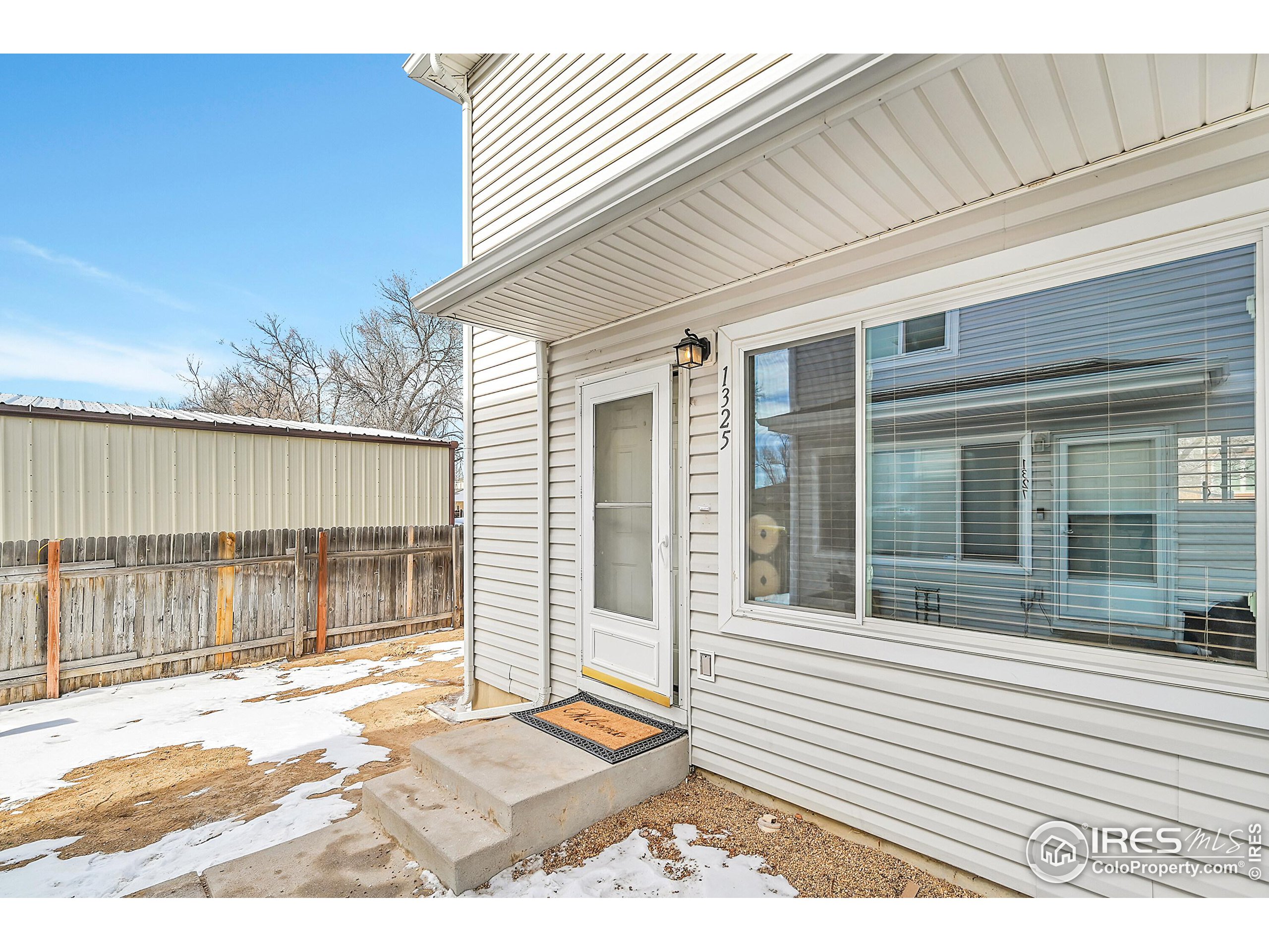 1325 Darrell Road Evans, CO 80620 - Photo 2 of 25 a view of a house with a small backyard