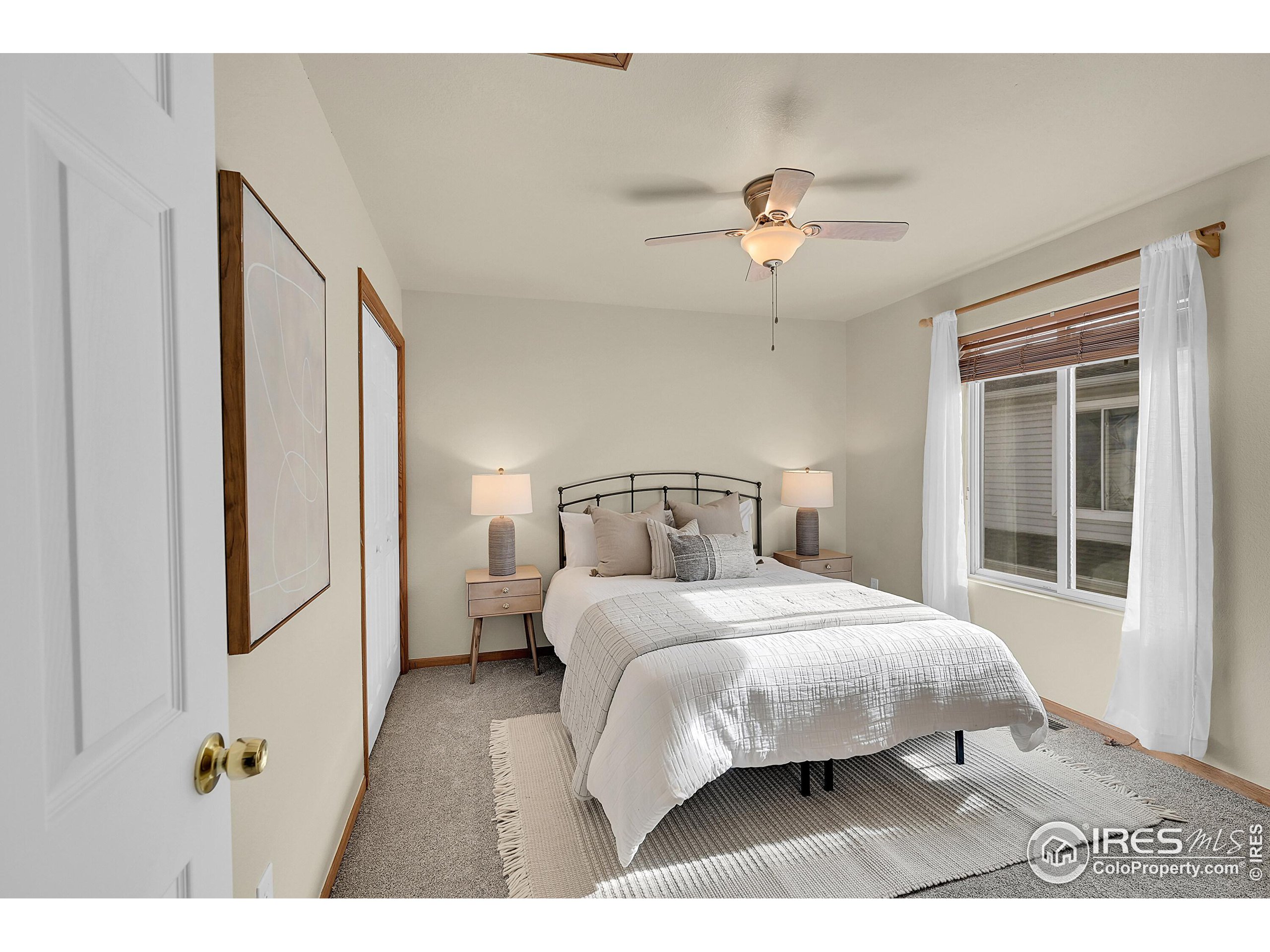 1325 Darrell Road Evans, CO 80620 - Photo 8 of 25 a bedroom with a bed and a chandelier