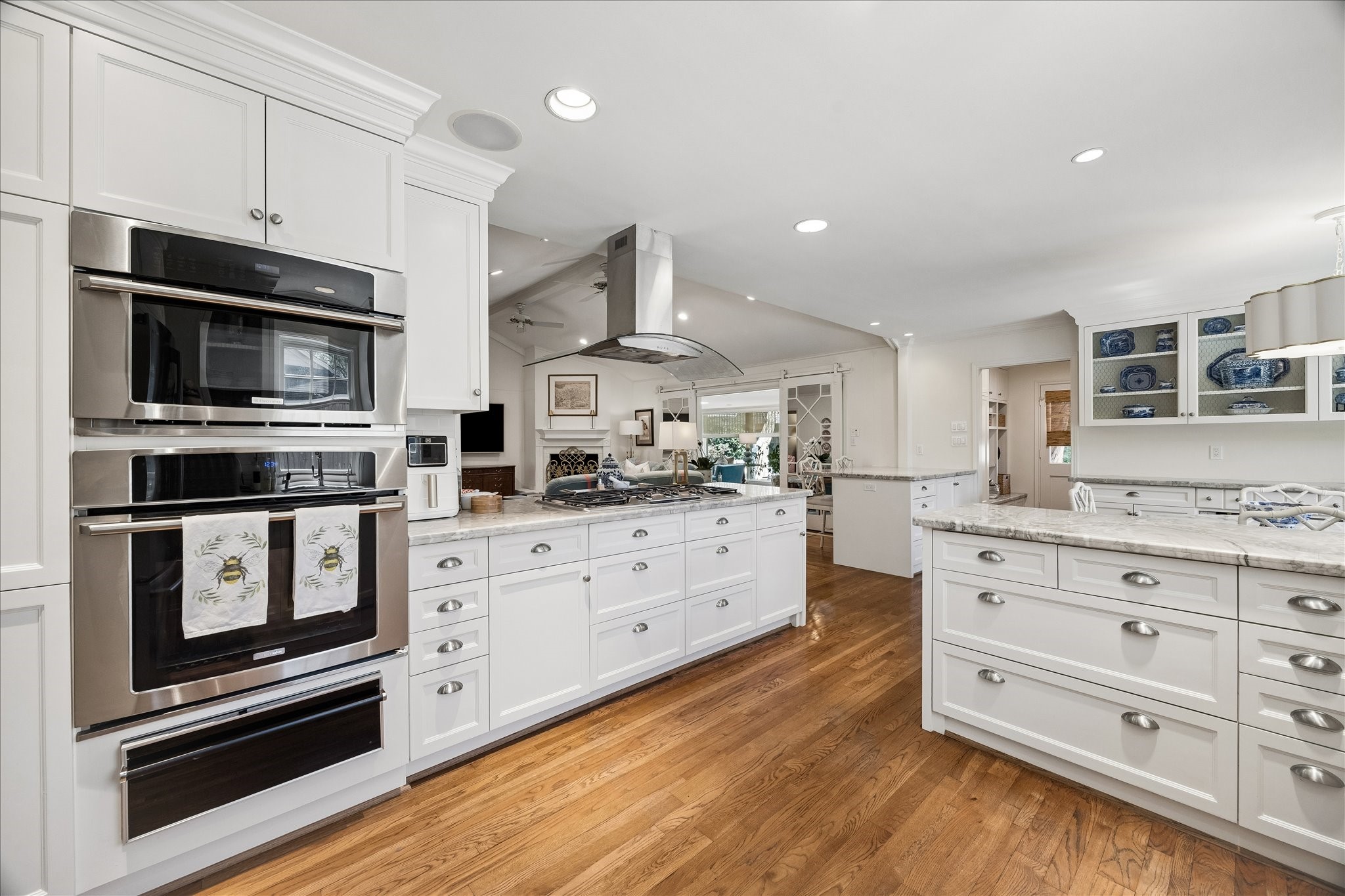 907 Wild Valley Road Houston, TX 77057 - Photo 12 of 31 a kitchen with stainless steel appliances cabinets and a wooden floor