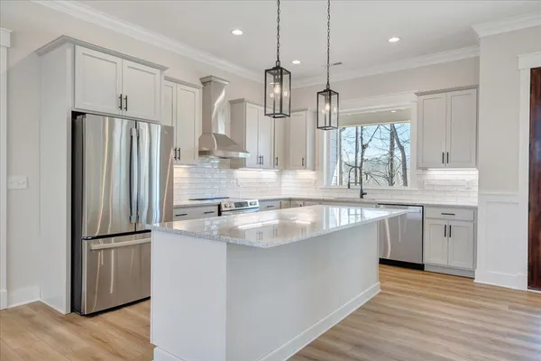 a bathroom with a double vanity sink a mirror and bathtub