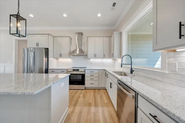 a spacious bathroom with a double vanity sink a mirror and a bathtub