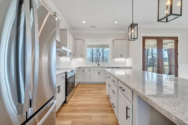 a view of a room with wooden floor